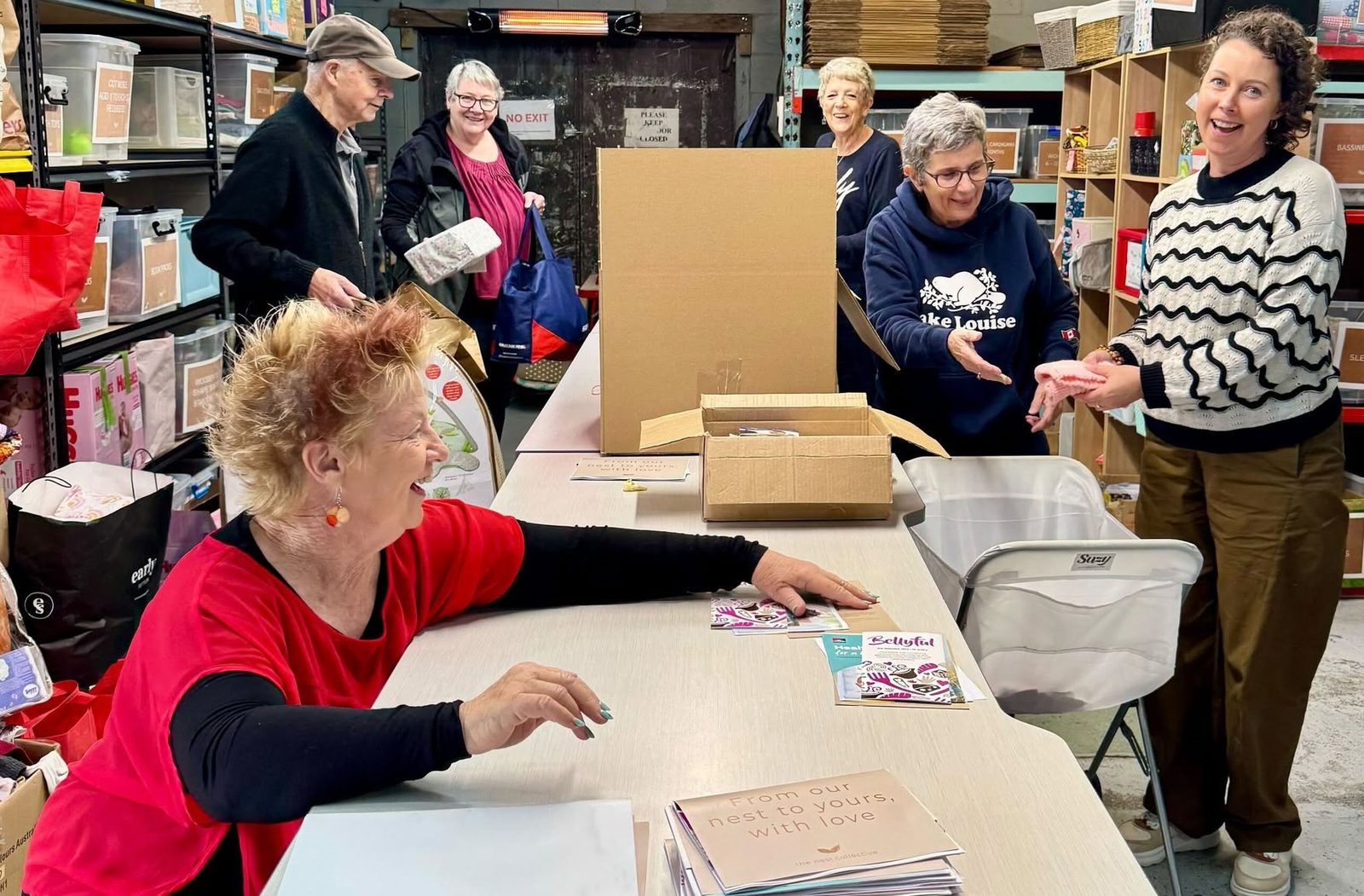 Nest Collective volunteers packing baby items